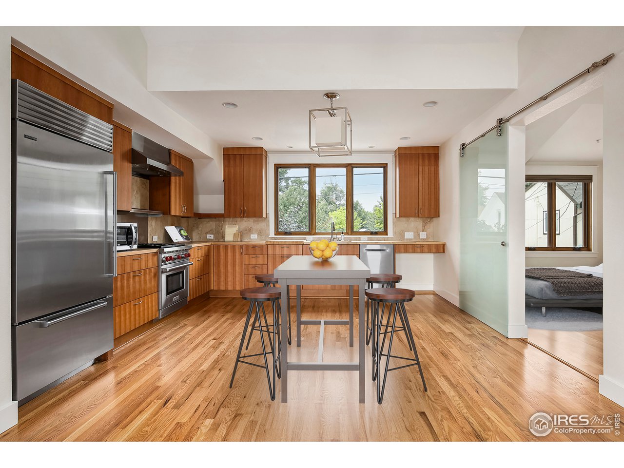 1933 Pearl Street, Unit 7 Boulder, CO 80302 - Photo 3 of 21 a living room with stainless steel appliances kitchen island granite countertop a refrigerator a sink a stove and a wooden cabinets
