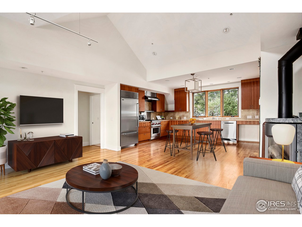 1933 Pearl Street, Unit 7 Boulder, CO 80302 - Photo 4 of 21 a living room with furniture and a flat screen tv
