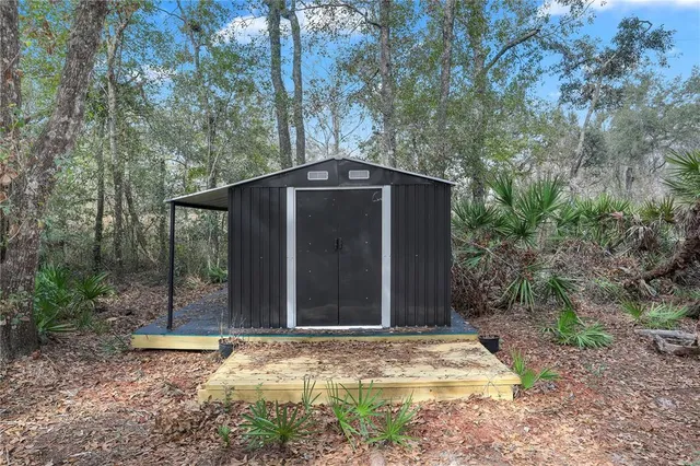 a backyard of a house with plants and trees