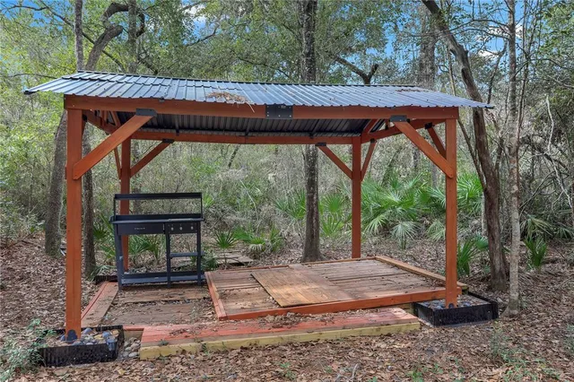 a view of a patio with a table chairs and a backyard