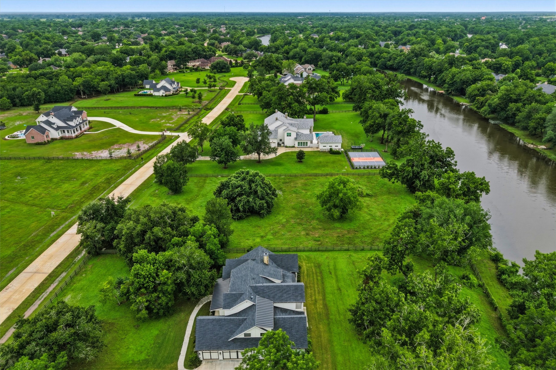 0 Riverlake Road Fulshear, TX 77441 - Photo 22 of 47 Another aerial perspective showcases the property's enviable riverfront location and expansive dimensions. Mature trees and open green space provide both privacy and endless design possibilities.