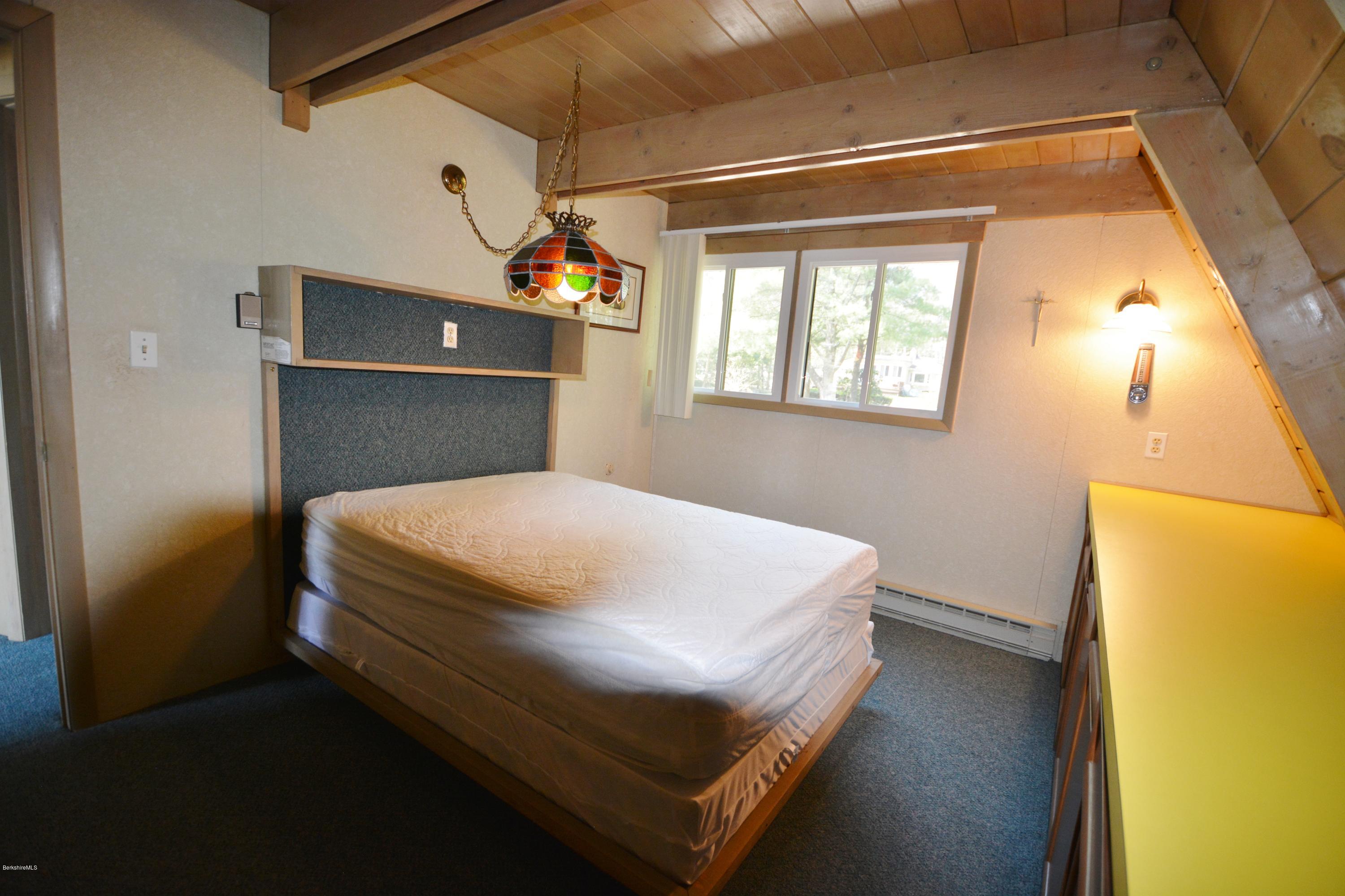 18 Moody Goodman Road Otis, MA 01029 - Photo 19 of 29 a bed sitting in a bedroom next to a window