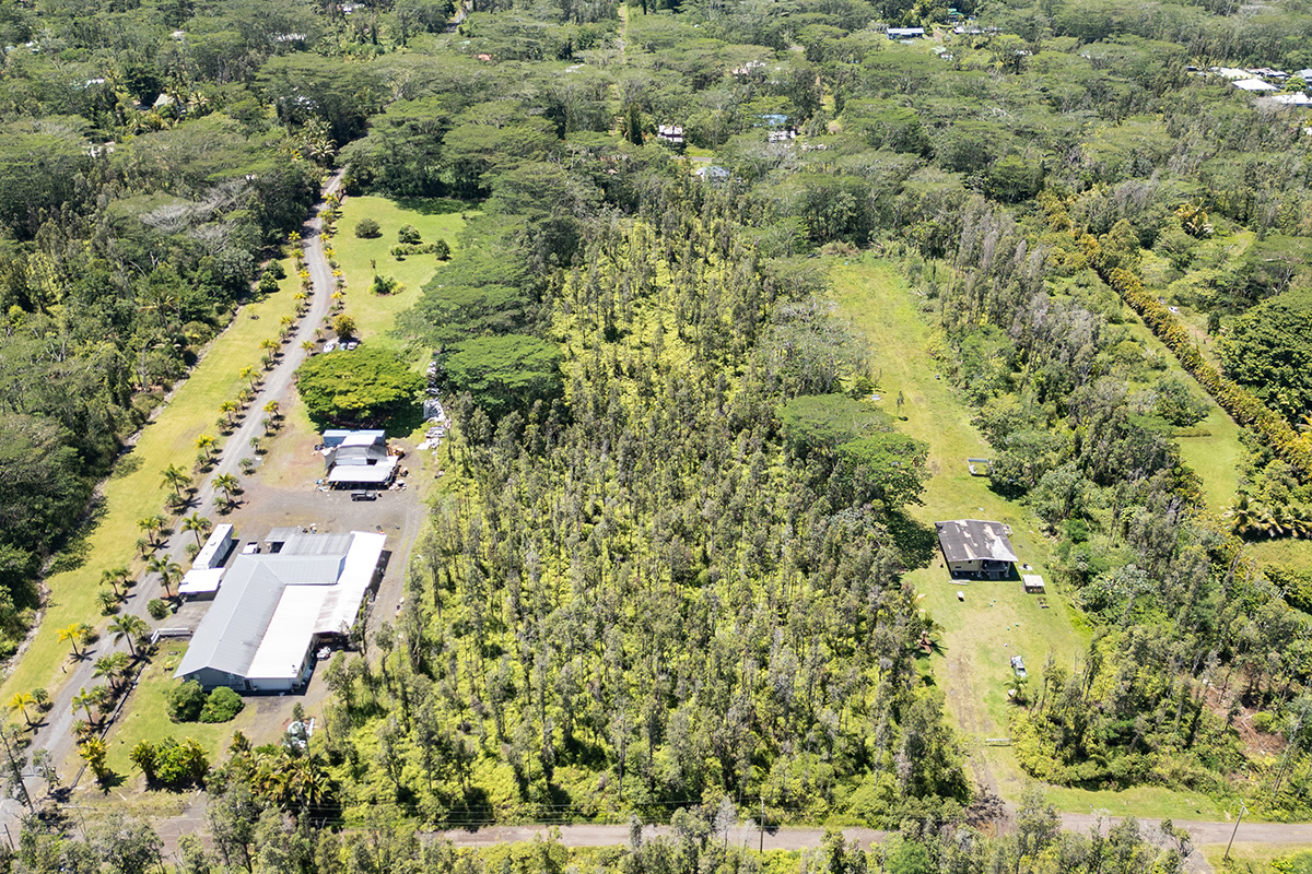 73 Nanawale Farms Road Pahoa, HI 96778 - Photo 13 of 15 an aerial view of a residential apartment building with a yard