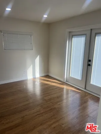 a view of room with window and wooden floor