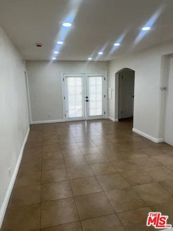 a view of an empty room and a window