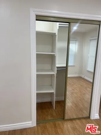 a room with wooden floor and closet