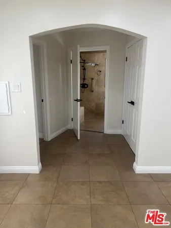 an empty room with wooden floor and closet