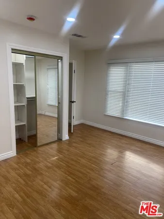 a bathroom with a granite countertop sink a mirror and shower