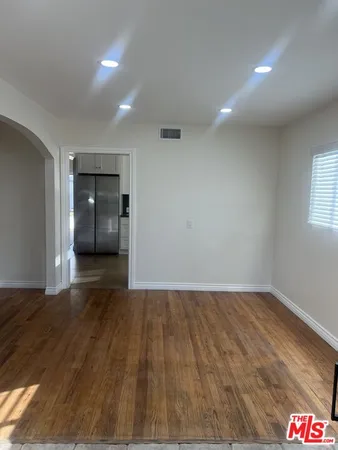 a view of kitchen with kitchen island white cabinets and stainless steel appliances