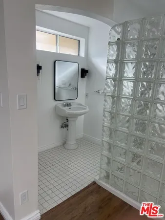 a bathroom with a shower and a sink