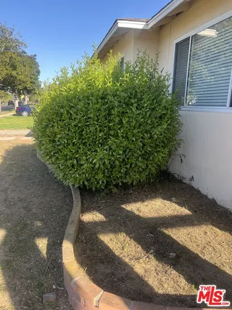 a view of a balcony with wooden floor and bench