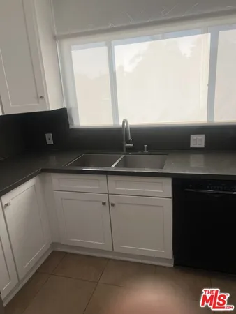 a kitchen with a sink and a window