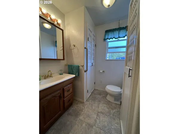 a spacious bathroom with a granite countertop sink toilet and shower