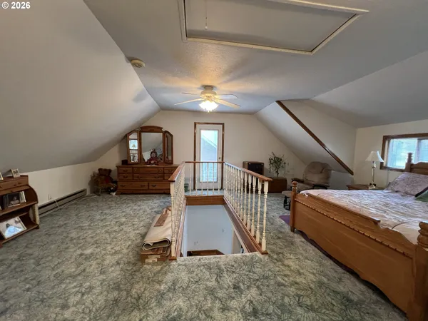 a living room with stairs and a wooden floor
