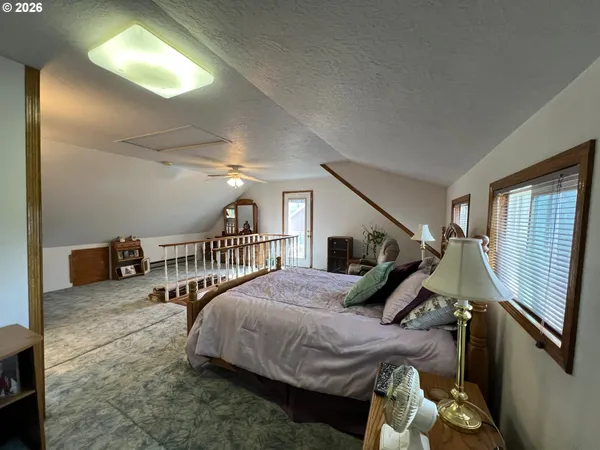 a bedroom with furniture and a window