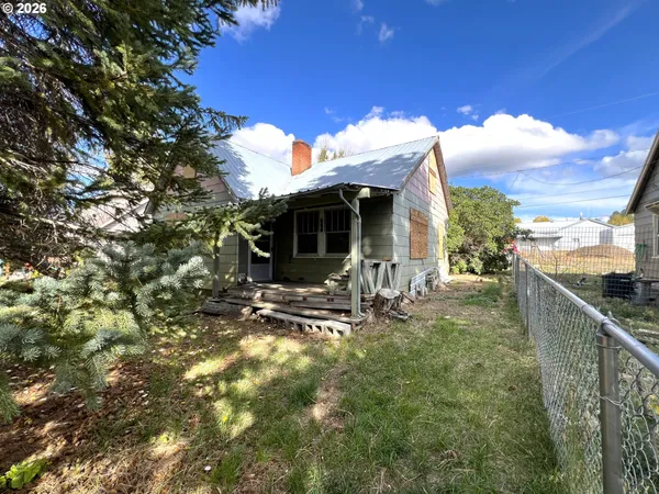 a view of a house with backyard porch and sitting area