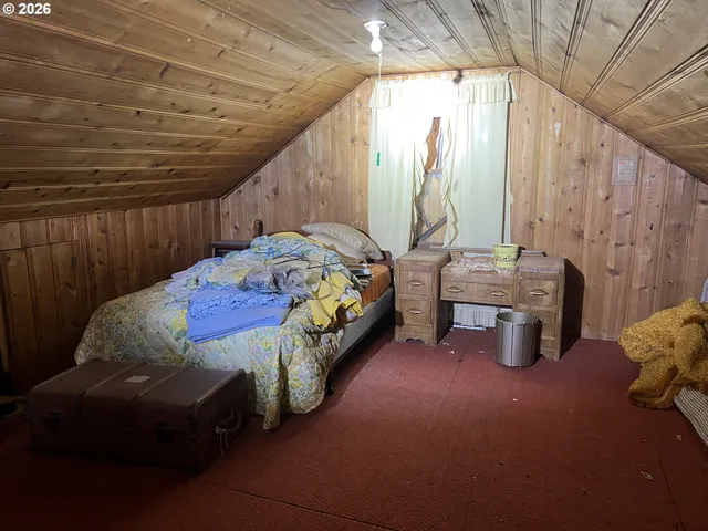a bed sitting in a bedroom next to a window