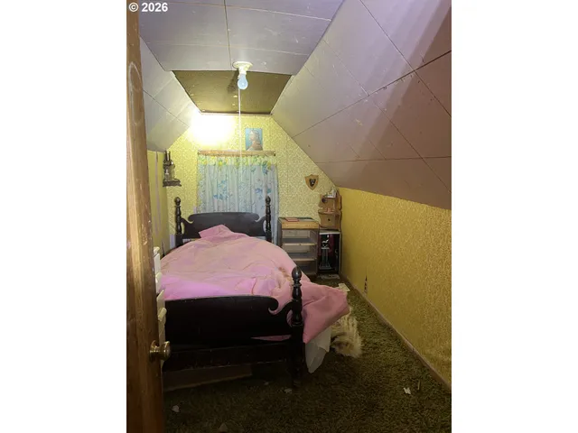 a bedroom with a bed and a mirror