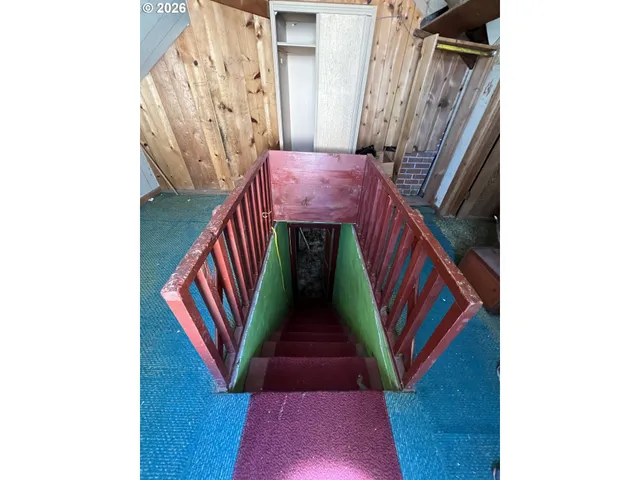 a view of a livingroom with furniture and staircase