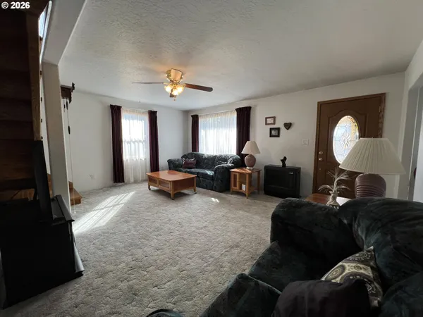 a living room with furniture and a mirror