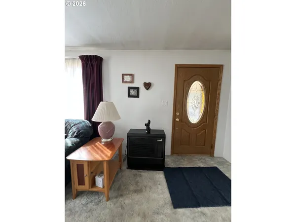 a living room with furniture and a mirror