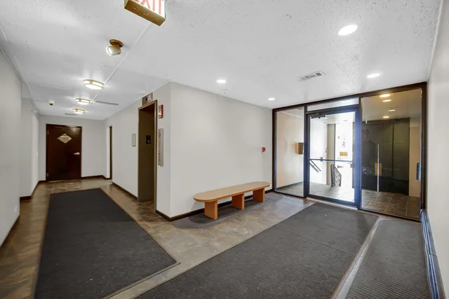 a view of a hallway with seating area