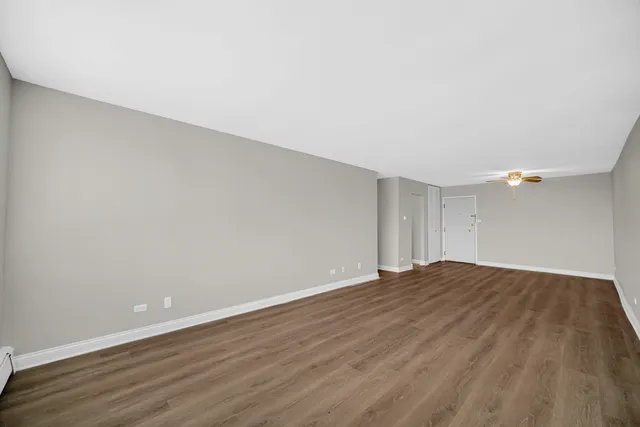a view of an empty room and wooden floor