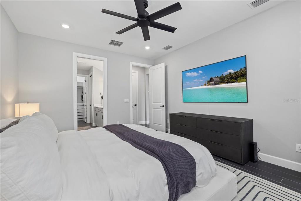 3508 Anchor Bay Trail Lakewood Ranch, FL 34211 - Photo 21 of 74 a bedroom with a bed and a painting on the wall