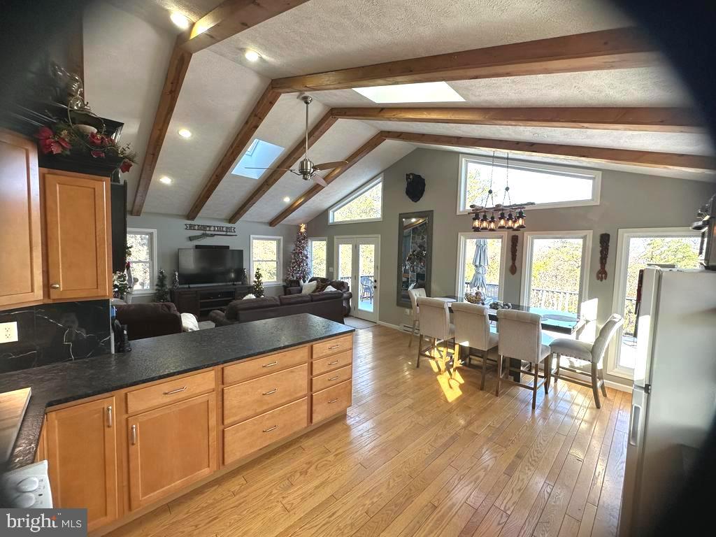 400 Locust Ridge Moorefield, WV 26836 - Photo 17 of 87 a large living room with stainless steel appliances granite countertop a couch a dining table and chandelier