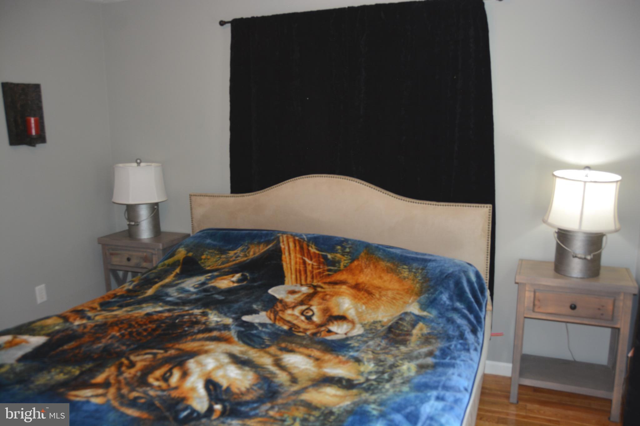 400 Locust Ridge Moorefield, WV 26836 - Photo 30 of 87 a bedroom with a bed and a lamp on dresser