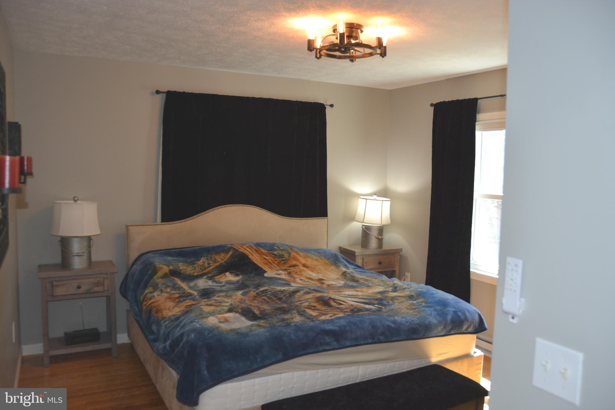 400 Locust Ridge Moorefield, WV 26836 - Photo 33 of 87 a bedroom with a bed and a lamp