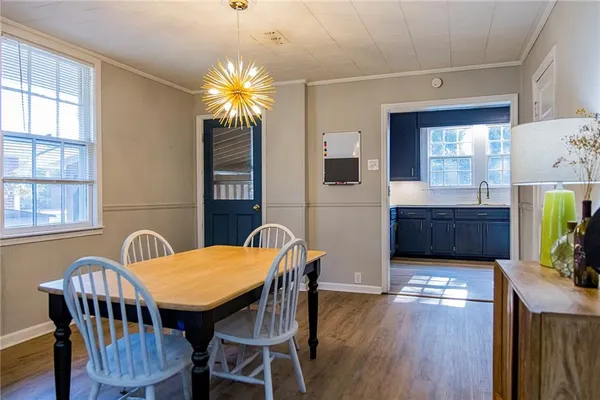a view of a dining room with furniture and a potted plant
