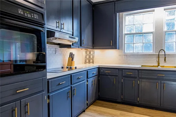 a kitchen with granite countertop wooden cabinets and a sink