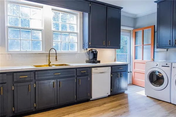 a kitchen with a sink and wooden cabinets