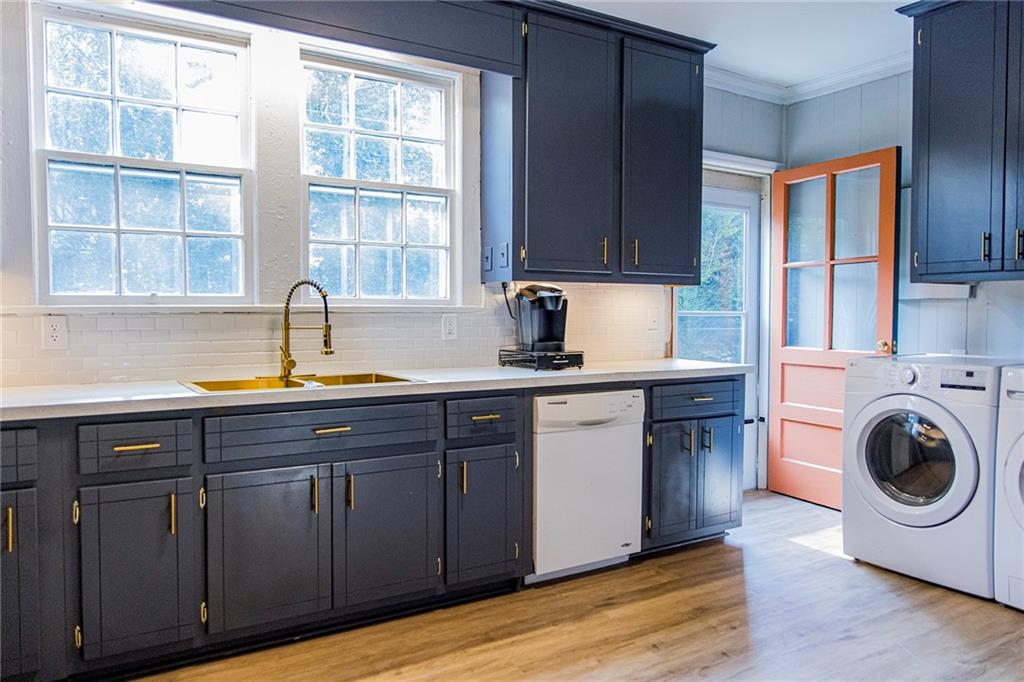 27 Oak Street Northeast Rome, GA 30161 - Photo 16 of 27 a kitchen with a sink and wooden cabinets