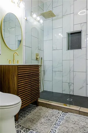 a bathroom with a sink a toilet and a mirror