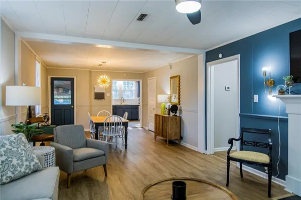 a living room with furniture and wooden floor