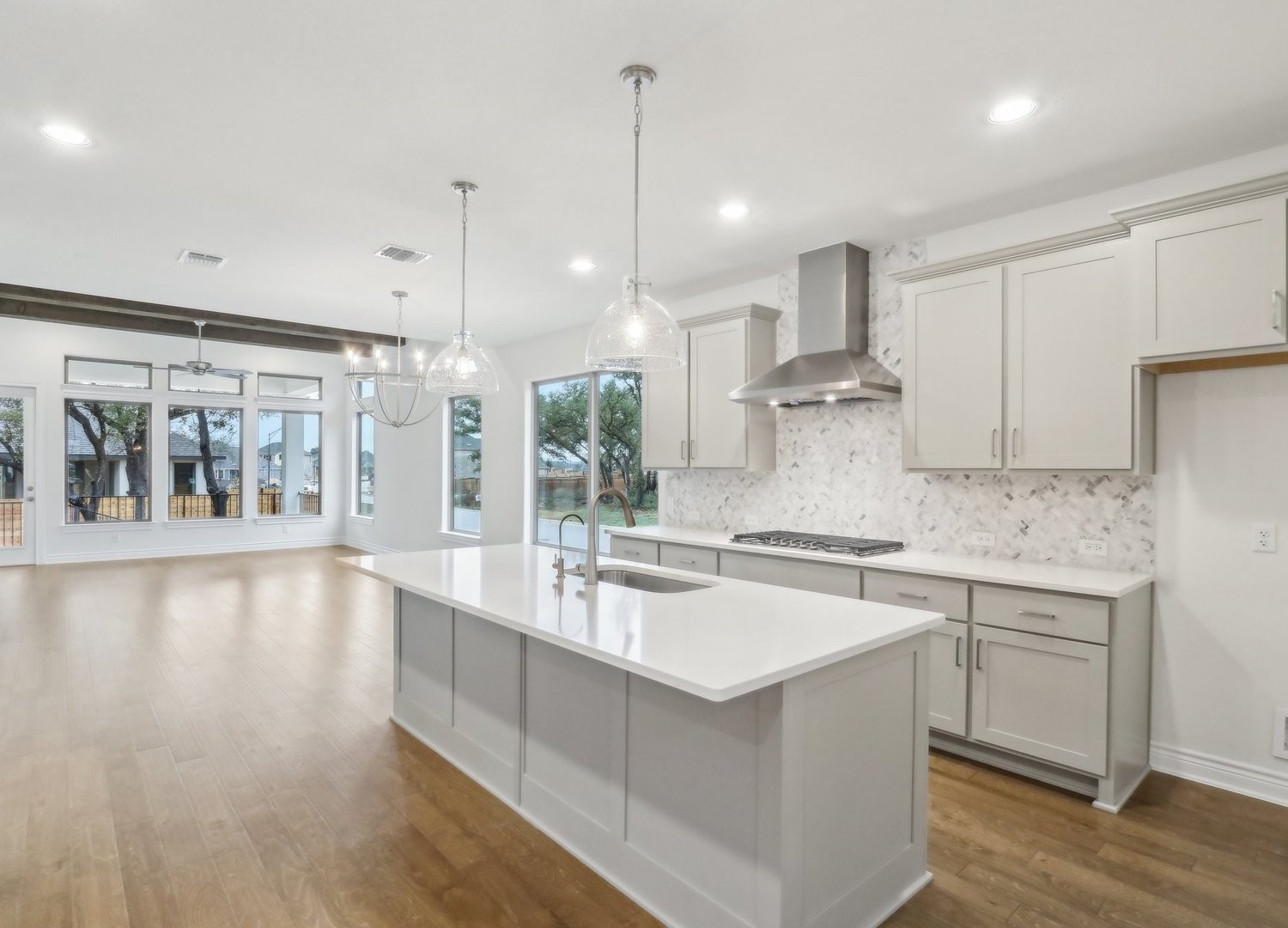 a large kitchen with kitchen island a sink stainless steel appliances and cabinets