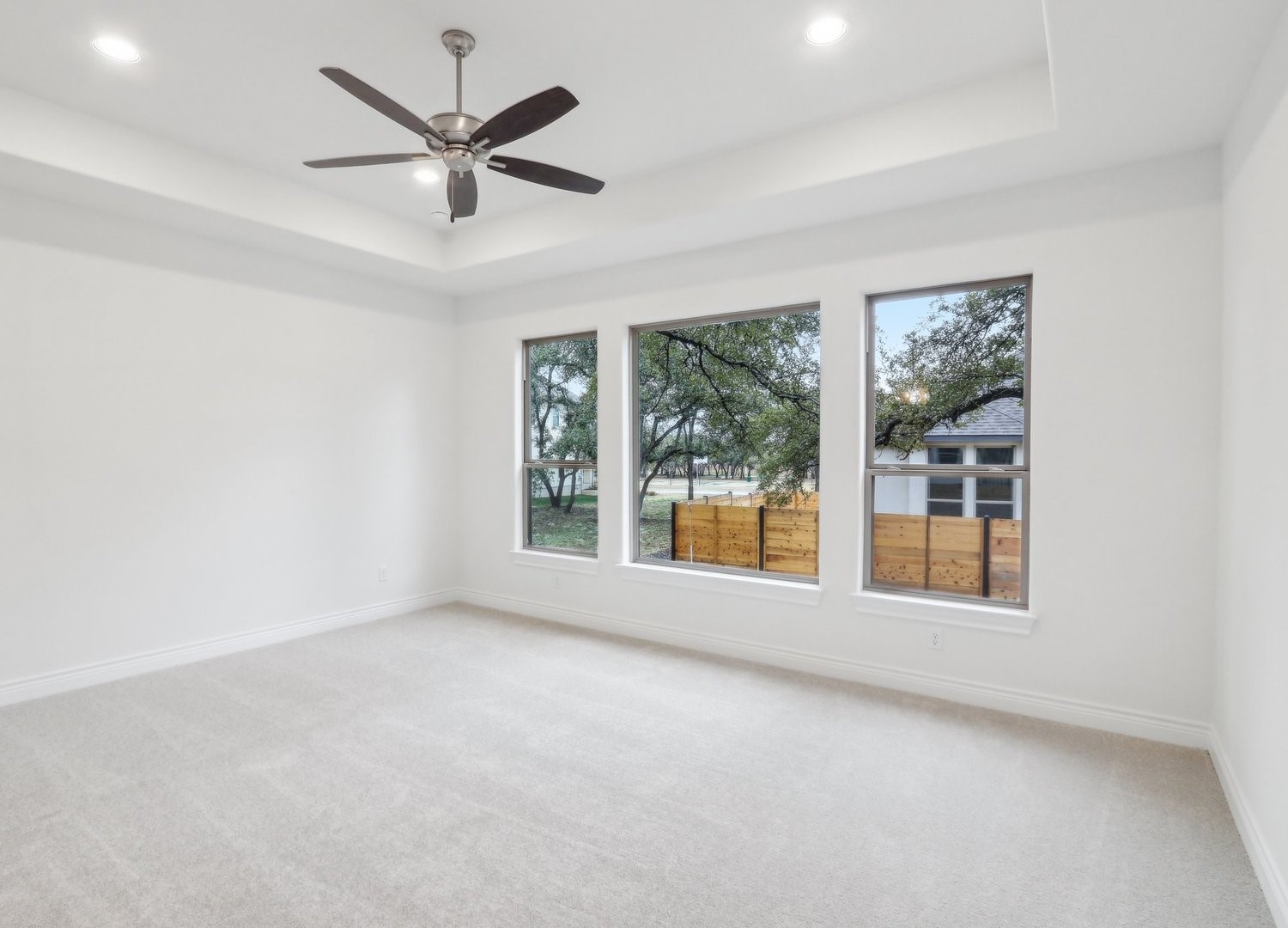 1129 Stonehill Drive Georgetown, TX 78633 - Photo 12 of 26 an empty room with windows and ceiling fan