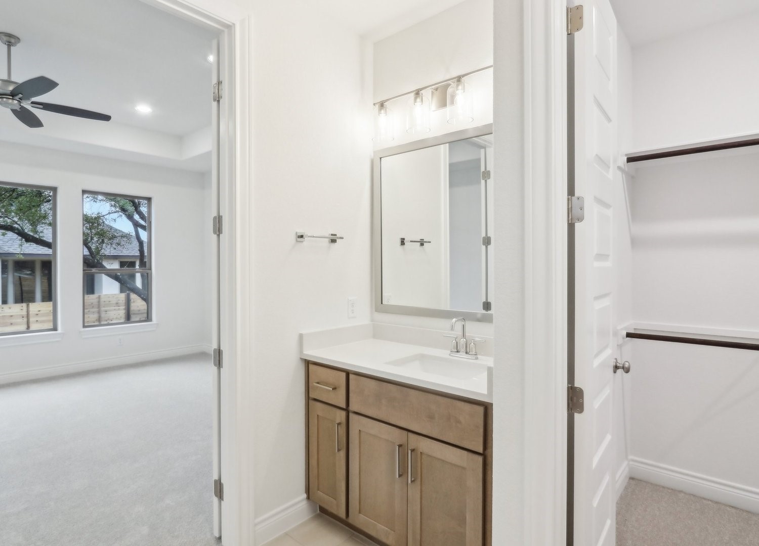 1129 Stonehill Drive Georgetown, TX 78633 - Photo 16 of 26 a bathroom with a granite countertop sink mirror and vanity