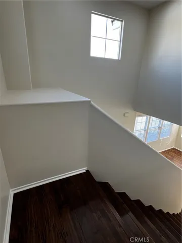 a view of wooden floor and staircase in a room