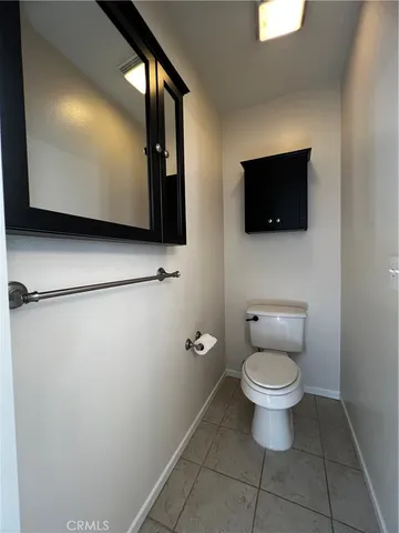 a bathroom with a toilet a sink and a mirror