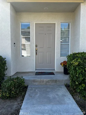 a view of backyard with entryway and potted plants