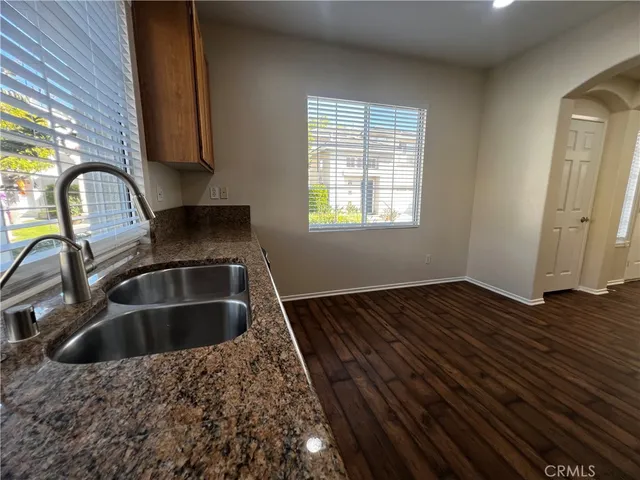 a kitchen with a sink and wooden cabinets
