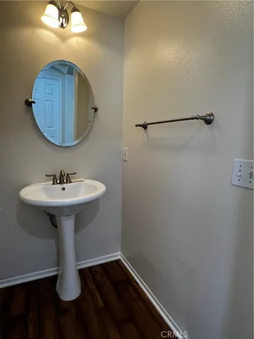 a bathroom with a sink a light fixture and a mirror