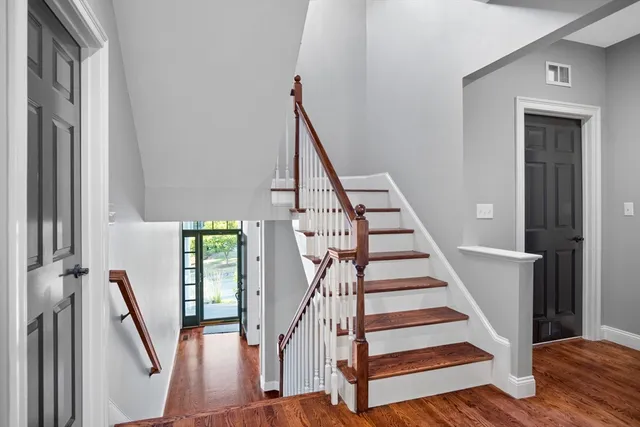 a view of entryway with wooden floor and stairs
