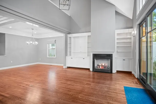a view of an empty room with window and fire place