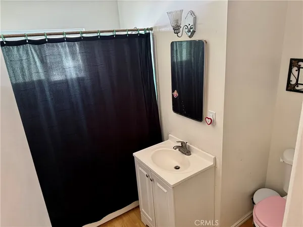 a bathroom with a sink toilet and mirror
