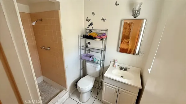 a bathroom with a sink a toilet and shower curtain