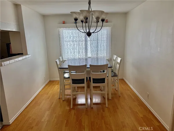 a view of a dining room with furniture wooden floor and chandelier